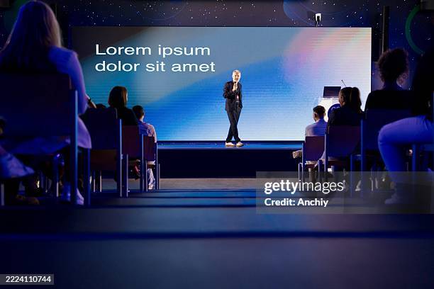 man presenting a professional keynote speech at a business technology conference - palestra imagens e fotografias de stock