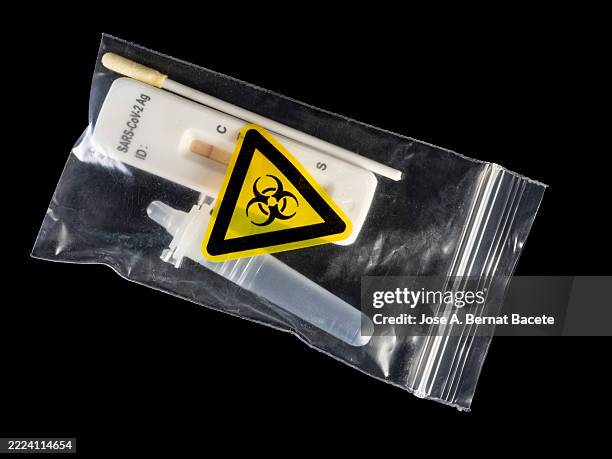 plastic bag containing a rapid covid-19 test. - rapid antigen stock pictures, royalty-free photos & images