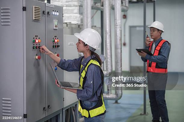 people work on electrical control panel - south east asia stock pictures, royalty-free photos & images