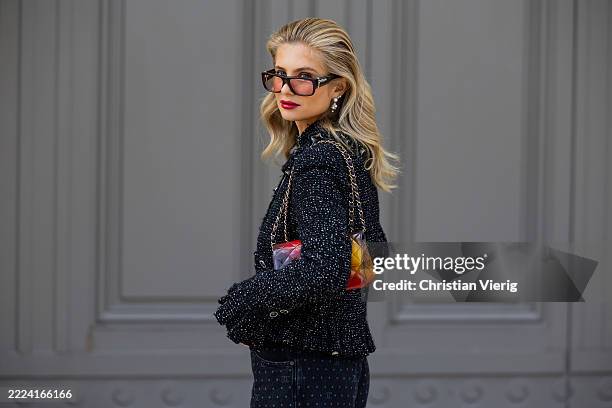 Xenia Adonts wears grey jacket, jeans with print, three tone bag, sunglasses outside Chanel during the Haute Couture Fall/Winter 2025/2026 as part of...