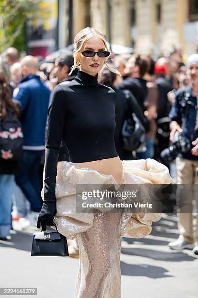 Leonie Hanne wears black cropped turtleneck, beige ruffled sequined skirt outside Stéphane Rolland during the Haute Couture Fall/Winter 2025/2026 as...