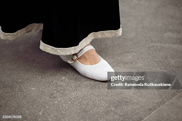 Veronika Heilbrunner wears black maxi skirt with white details and white ballerinas outside Chanel show during the Haute Couture Fall/Winter...
