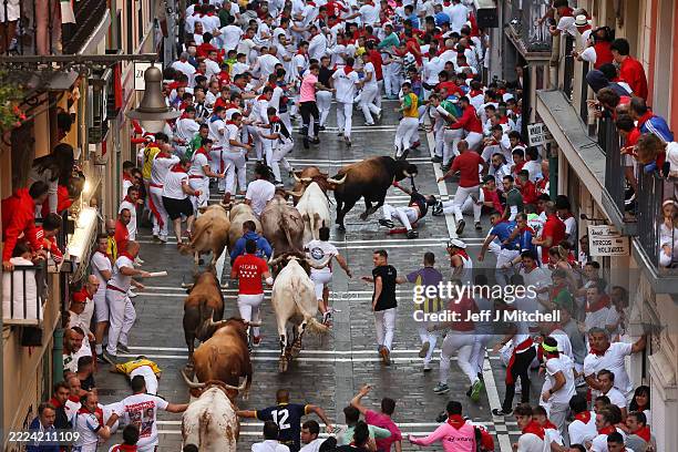 Revellers run with bulls along Calle Estafeta during the San Fermin Running of the Bulls festival on July 09, 2025 in Pamplona, Spain. During the...