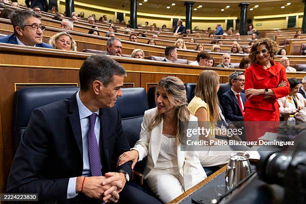 Spanish Prime Minister Pedro Sanchez chats with Deputy Prime Minister Yolanda Diaz at the start of a plenary session at the Spanish Parliament on...