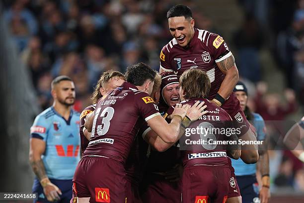 Harry Grant of the Maroons celebrates a try with team mates during game three of the Men's State Of Origin series between New South Wales Blues and...