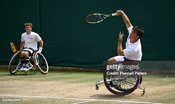 Dahnon Ward of Great Britain serves with Ben Bartram of Great Britain against Zhenxu Ji of People's Republic of China and Sergei Lysov of Israel...