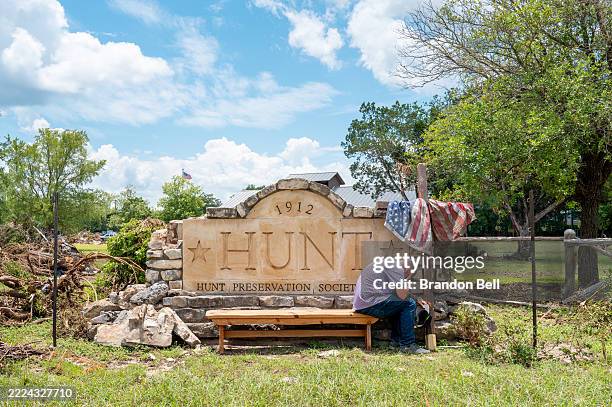 Nathan Sharpe grieves at the entrance to the Hunt city square on July 09, 2025 in Hunt, Texas. Last Friday, heavy rainfall caused severe flash...