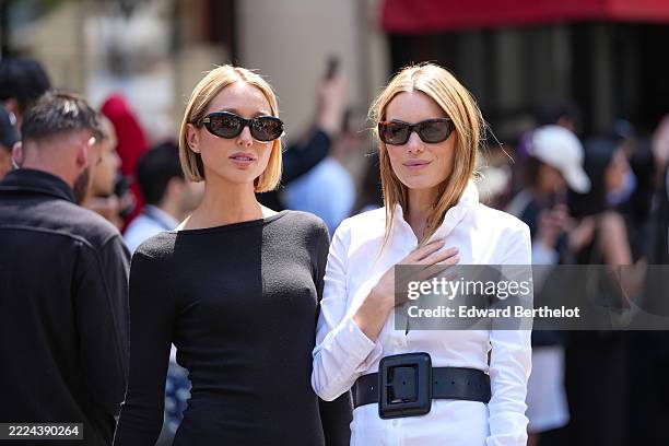 Princess Maria Olympia of Greece wears a black long-sleeve mini dress with a fitted silhouette. Sunglasses with dark lenses and a black frame are...
