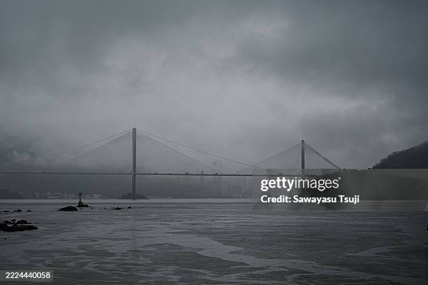 Thick cloud and heavy rain cover sections of the bridge on July 10, 2025 in Hong Kong, China.