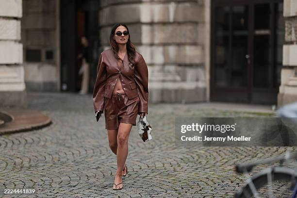 Anna Winter is seen wearing oval Havana-framed sunglasses with thin temples from Saint Laurent; a yellow gold “B.zero1” necklace from Bulgari; an...