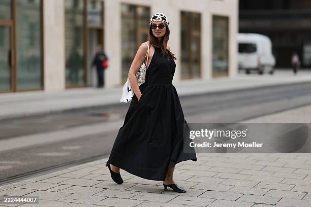 Anna Winter is seen wearing a white crochet cap in a star pattern from Mango; oval Havana-framed sunglasses with thin temples from Saint Laurent; a...