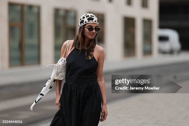 Anna Winter is seen wearing a white crochet cap in a star pattern from Mango; oval Havana-framed sunglasses with thin temples from Saint Laurent; a...