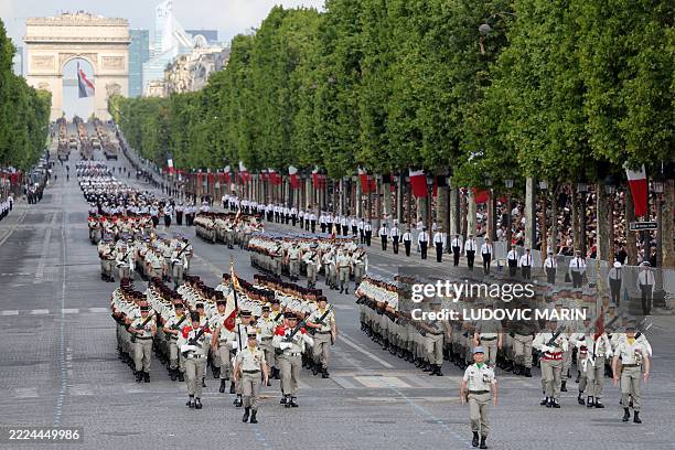 France's 35e Regiment d'Infanterie - l'As de Trefle members and France's 1er Regiment de Tirailleurs members parade during the annual Bastille Day...
