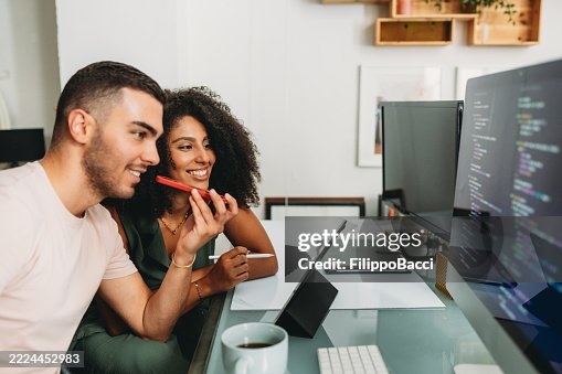 Programmers working together using voice assistant on smartphone Programmers working together using voice assistant on smartphone