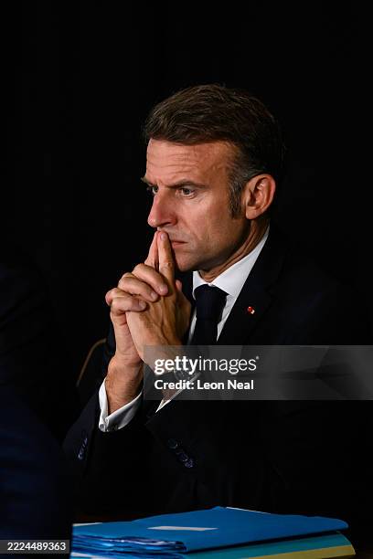 French President Emmanuel Macron listens as he co-hosts a meeting of the Coalition of the Willing with UK Prime Minister Keir Starmer during a joint...
