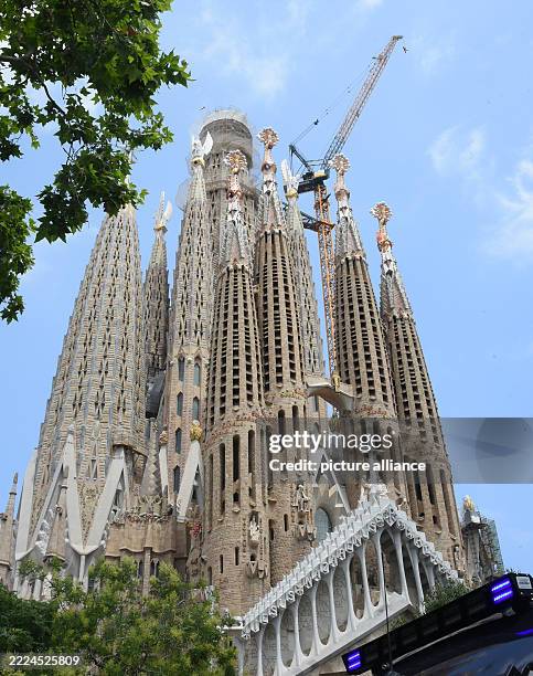 July 2025, Spain, Barcelona: The photo shows the exterior façade of the famous Sagrada Familia cathedral in Barcelona. The Unesco World Heritage site...