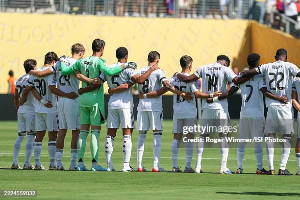 Real Madrid line up for a moment of silence before the FIFA Club World Cup 2025 quarter-final match between Real Madrid CF and Borussia Dortmund at...