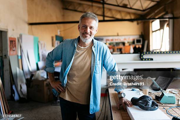 smiling engineer posing in his workshop with 3d printer - old man smart stock pictures, royalty-free photos & images