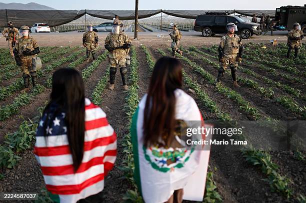 National Guard soldiers block protestors during an ICE immigration raid at a nearby cannabis farm on July 10, 2025 near Camarillo, California....