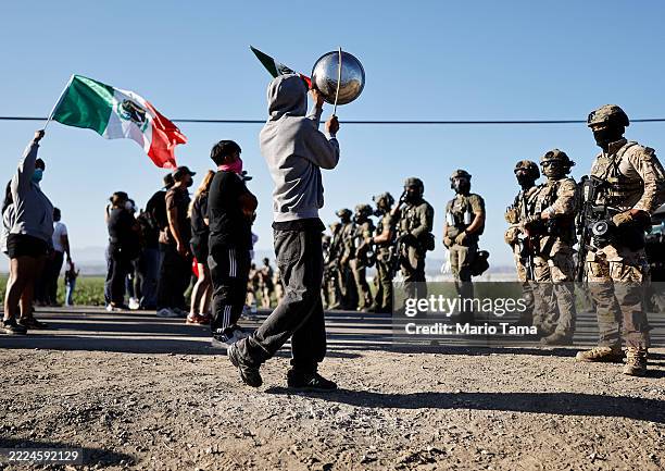 Federal agents block people protesting an ICE immigration raid at a nearby licensed cannabis farm on July 10, 2025 near Camarillo, California....