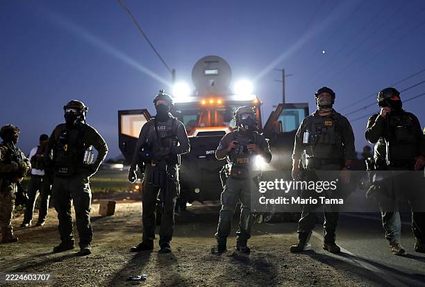 Federal agents block people protesting an ICE immigration raid at a nearby licensed cannabis farm on July 10, 2025 near Camarillo, California....