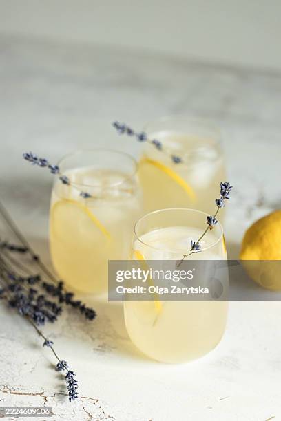 summer lemonade with lavender on white table. - lemon soda stock pictures, royalty-free photos & images