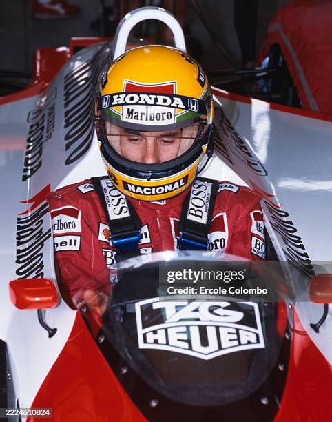 Ayrton Senna from Brazil sitting in the cockpit of the Honda Marlboro McLaren McLaren MP4/4 Honda RA168E V6 turbo before practice for the Formula One...