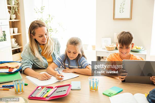 kids doing homework in the kitchen - homeschooling stock pictures, royalty-free photos & images