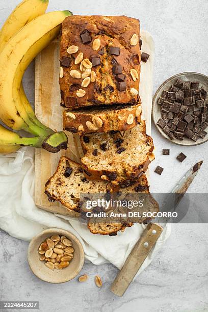 homemade banana bread with chocolate chips and peanuts - banana bread stock pictures, royalty-free photos & images