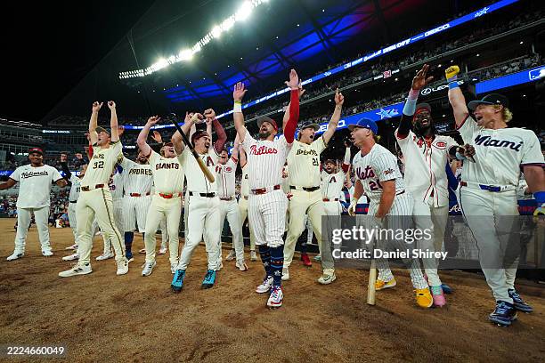Kyle Schwarber of the Philadelphia Phillies celebrates with teammates after hitting three home runs in three swings to win the Inaugural All-Star...