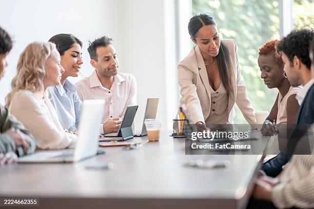 diverse team collaborating in a modern office during a business meeting - initiative stock pictures, royalty-free photos & images