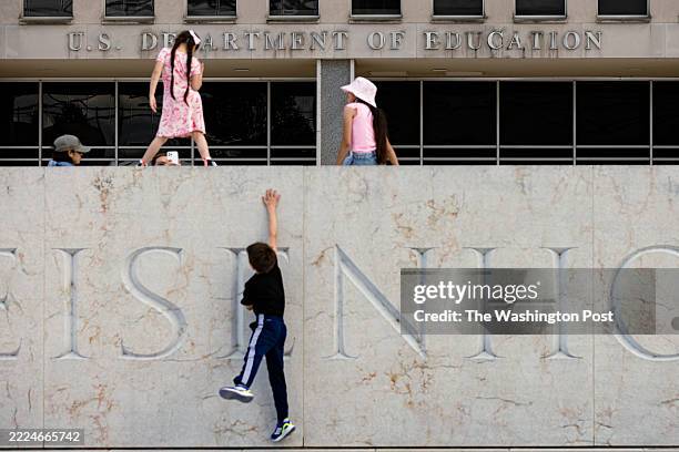 Children play on the Dwight D. Eisenhower Memorial in front of the Department of Education headquarters in Washington, D.C., on Sunday, May 18, 2025.