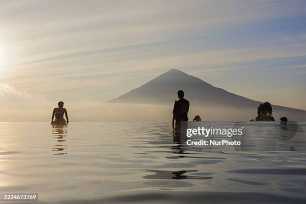 People swim in a hot spring pool whose water comes from the Papandayan volcano in Tepas Papandayan, Garut, West Java, Indonesia, on July 16, 2025....