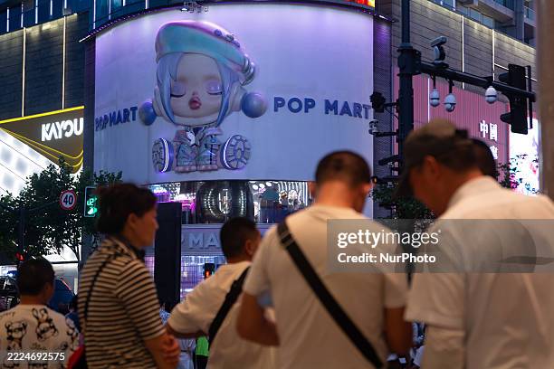 General view of Pop Mart is illuminated at night on Nanjing East Road in Shanghai, China, on July 16, 2025.