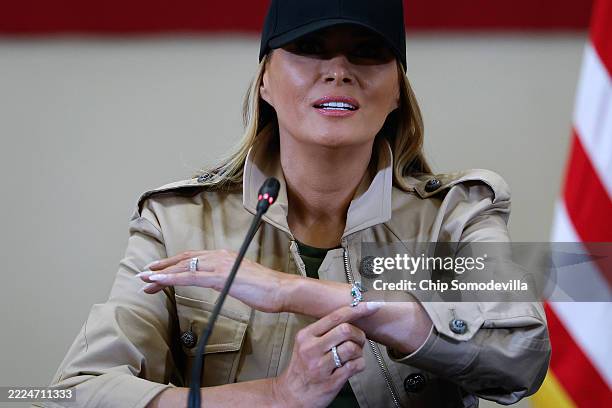 First lady Melania Trump shows a bracelet she said she was given as a memento to the girls killed in last week's flash flooding during a roundtable...