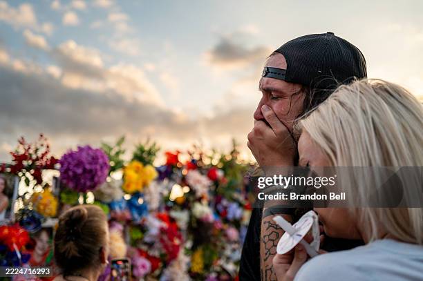 Community members grieve during a candlelight vigil to honor the lives lost in the flash floods that claimed more than 120 lives on July 11, 2025 in...