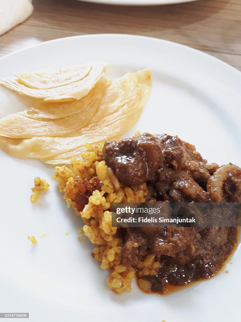 Hearty Beef Curry with Yellow Rice and Roti Paratha