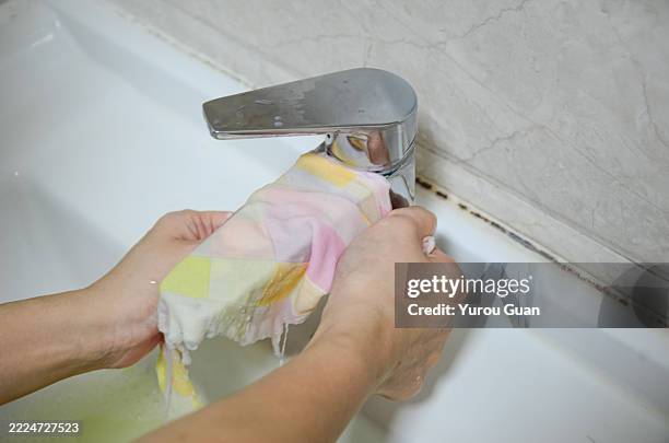 asian woman cleaning bathroom sink and faucet.home hygiene concept. - tapping stock pictures, royalty-free photos & images