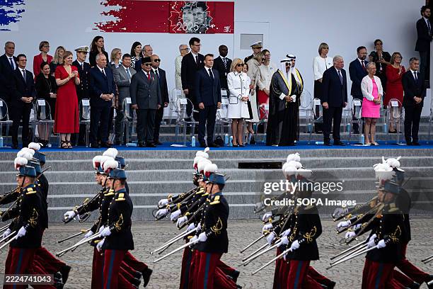 The French President Emmanuel Macron stands with the Indonesian President Prabowo Subianto on his left at the Presidential Tribune during the annual...
