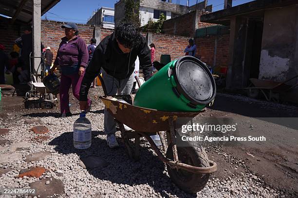 Man transports water on tanks during a water shortage on July 16, 2025 in Quito, Ecuador. Ecuador, and especially Quito, is going through the most...