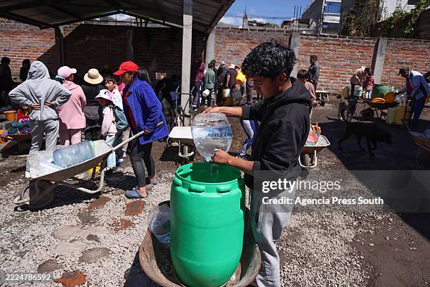 Man fills water in a tank during a water shortage on July 16, 2025 in Quito, Ecuador. Ecuador, and especially Quito, is going through the most...