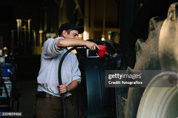 farmer refuel the tractor at the gas station - tractor stock pictures, royalty-free photos & images