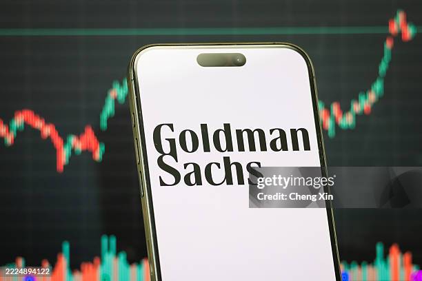 In this photo illustration, a smartphone displaying the logo of The Goldman Sachs Group, Inc. , a leading American multinational investment bank and...