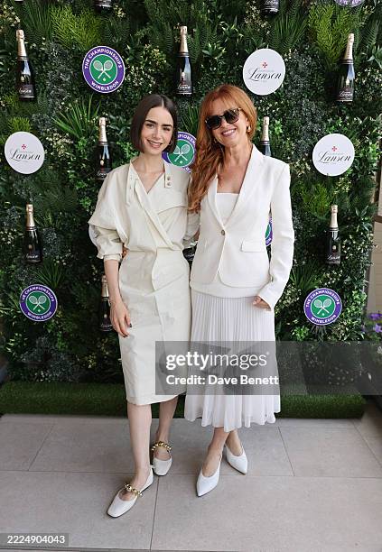 Lily Collins and Isla Fisher with Champagne Lanson at The Championships in Wimbledon at Agapanthus Suite on July 13, 2025 in Wimbledon, England.