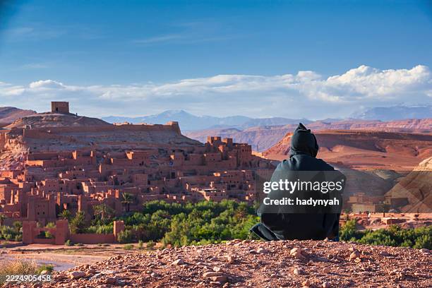 maroccan man looking at aït benhaddou - moroccan culture stock pictures, royalty-free photos & images