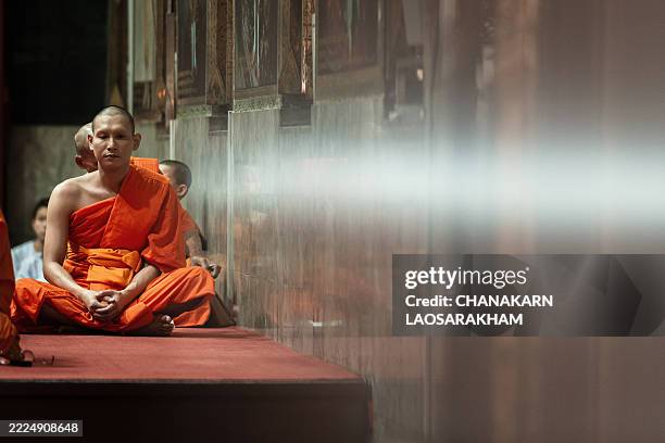 Thai Buddhist monks prays at Wat Pak Nam temple in Bangkok on July 18, 2025. / To go with 'THAILAND-MONKS-RELIGION-CRIME,FOCUS' by Montira...