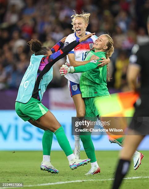 England goalkeeper Khiara Keating and Esme Morgan celebrate with goalkeeper Hannah Hampton after they win the penalty shootout during the UEFA Womens...