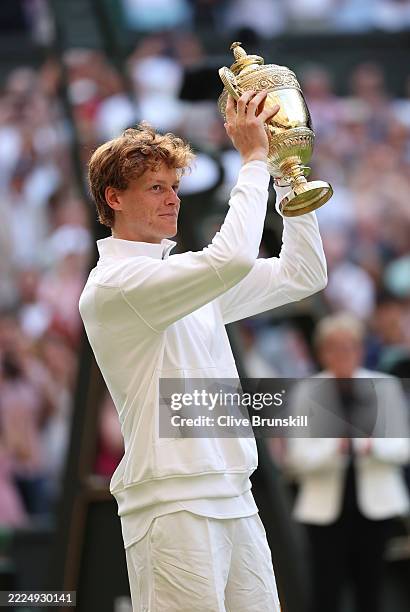 Jannik Sinner of Italy lifts the Gentlemen’s Singles Trophy following his victory against Carlos Alcaraz of Spain during the Gentlemen’s Singles...