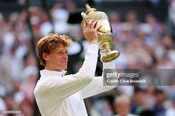 Jannik Sinner of Italy lifts the Gentlemen’s Singles Trophy following his victory against Carlos Alcaraz of Spain during the Gentlemen’s Singles...