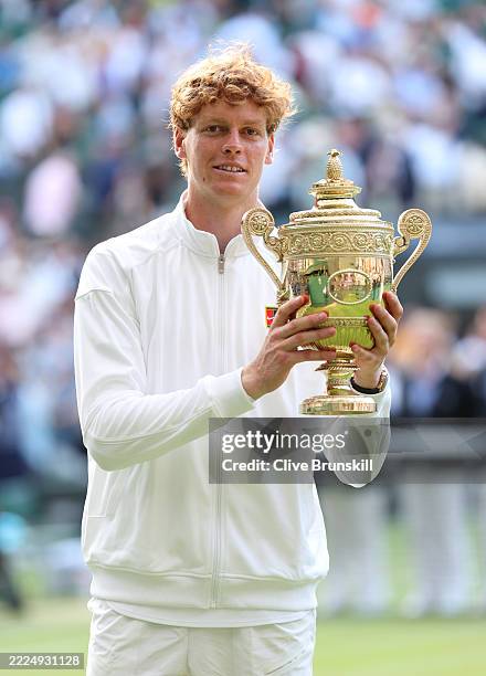 Jannik Sinner of Italy poses with the Gentlemen’s Singles Trophy following his victory against Carlos Alcaraz of Spain during the Gentlemen’s Singles...